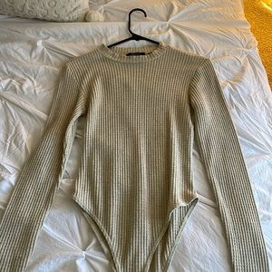 Tan body suit with high cut neck